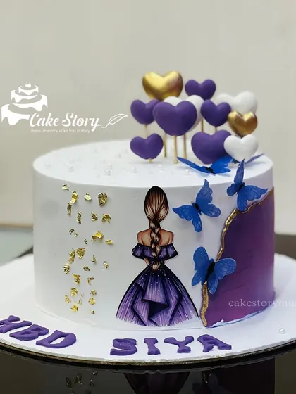 Another view of this beautiful purple-themed cake, showing the details of the edible gold leaf and the arrangement of the heart toppers.