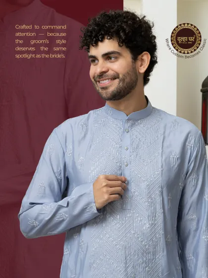 Crafted to command attention. A close-up of a model in a light blue embroidered kurta, showcasing the detailed threadwork.