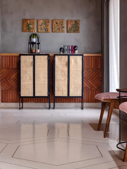A closer look at the material palette, with the hexagonal patterned floor, rattan and metal cabinets, and the textured brickwork. Each element was chosen to contribute to the office's industrial-chic aesthetic.
