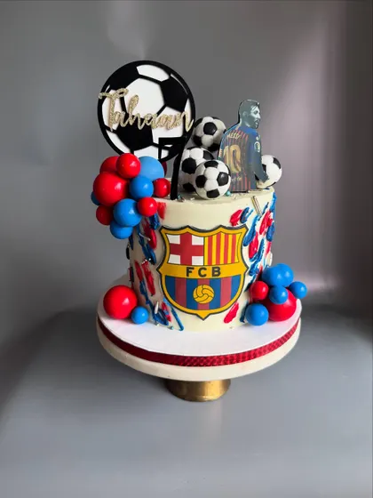 Another shot of the FCB-themed cake, showing the personalized name topper and Messi figurine.