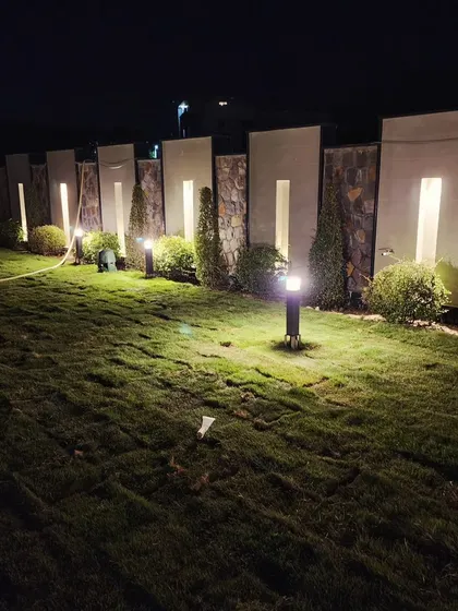 The completed lawn at our Gurugram project, with integrated lighting creating dramatic shadows and highlighting the architectural features of the boundary wall.