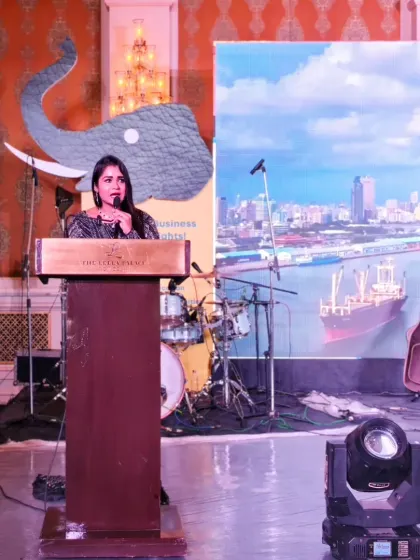 On stage at the SolutionX Summit, with the event's thematic branding in the background. I ensure the focus remains on your brand and message.