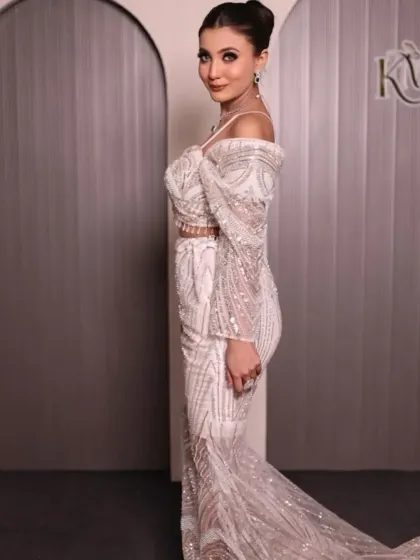 A side view of the white and silver gown, showing its elegant silhouette.