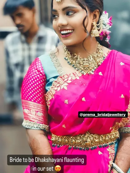Bride-to-be Dhakshayani looking joyful in a bright pink saree and antique gold jewellery for one of her pre-wedding functions.