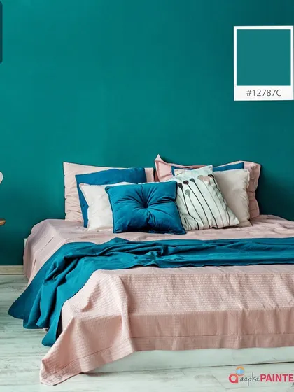 This bedroom showcases a bold teal accent wall paired with soft pink bedding. This colour combination is both vibrant and soothing, creating a stylish and personalized space.