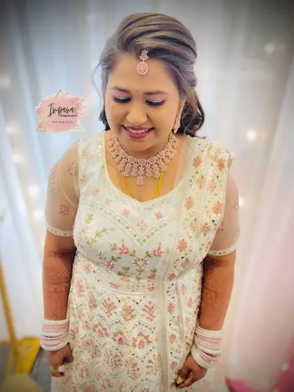 The bride smiling, looking confident and beautiful. The complete look, from the hairstyle to the makeup, is tailored to her preference for a modern yet timeless reception style.