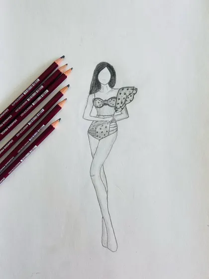 A pencil sketch of a swimsuit design. Rendering with pencils helps in understanding light and shadow to give the drawing a 3D form.