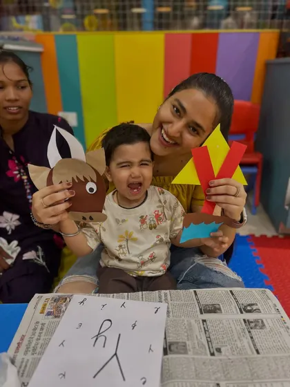 Even when a child is tearful, the creative process continues with the support of their parent. This real moment at our Rajouri Garden center shows a mother and child with their paper crafts, reminding us that learning has its ups and downs.