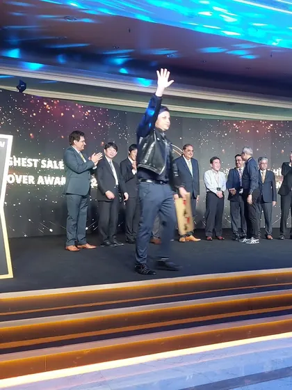 Taking the stage at the Daikin annual awards. My customized mental magic act involved the audience revealing the winner's name, making the awards ceremony interactive and unpredictable.