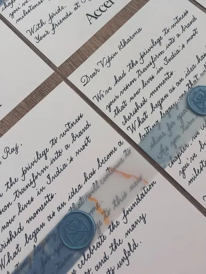 A little note of appreciation goes a long way. These notecards were hand-written for a private event for Accel, featuring classic black ink on white paper with a blue vellum band and a custom wax seal.