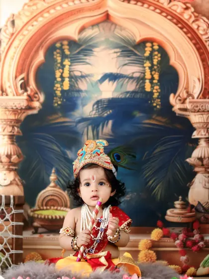 This little Krishna holds a small flute, looking inquisitively towards the camera in our ornate temple-themed setting.