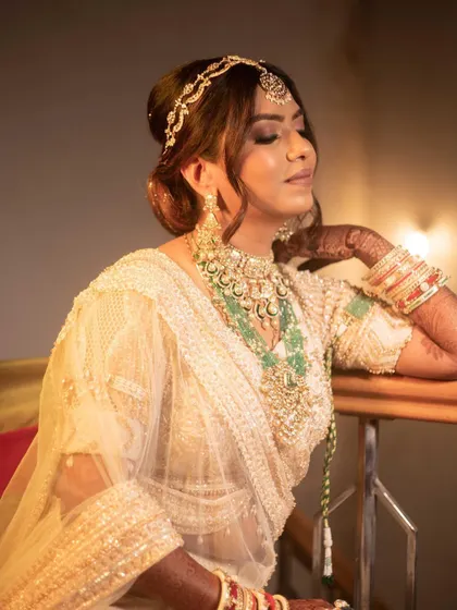 A close-up of Aanchal's stunning bridal makeup. The soft smokey eye and perfectly contoured features create a look of timeless beauty.