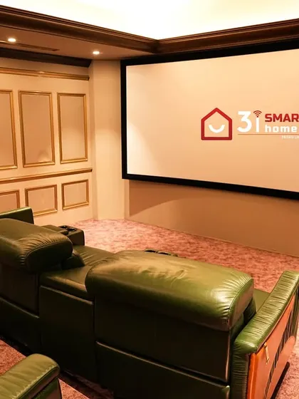 A view from the back, showing the massive screen and the elegant, classically inspired wall paneling with gold trim.