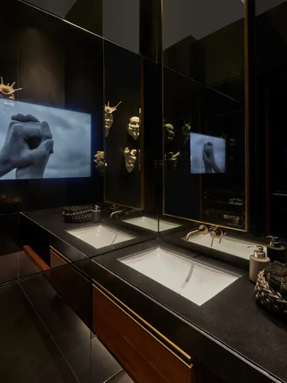 This washroom in the Baid Residence fuses art and utility, featuring digital artwork from the Kochi Biennale. The design demonstrates our belief that every corner of a home can be a canvas for creativity.