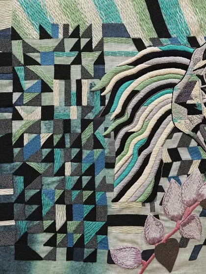 This is the "Mare in her field," a companion piece to the horse tapestry. The cool palette of blues and greens in the embroidery reflects her calm and royal nature. This work celebrates the sensitive yet strong leadership qualities of female animals.