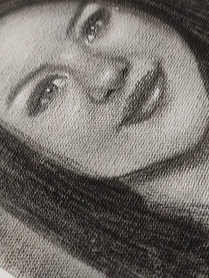 A close-up, angled shot of the Selena Gomez drawing, emphasizing the texture of the canvas.