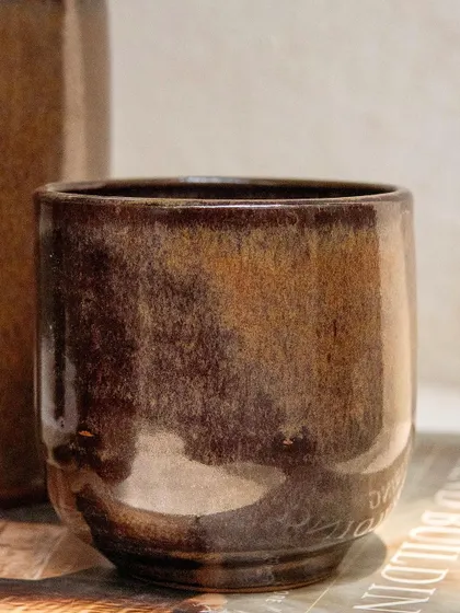 A detailed shot of our Copper Patina glaze. The interplay of light and the metallic surface creates a dynamic and visually interesting finish.