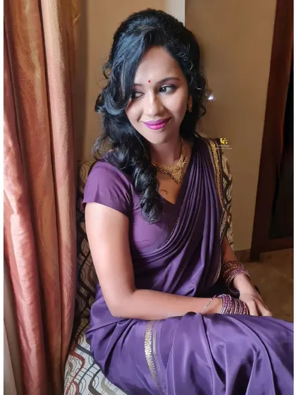 A lovely candid photo of Vaishnavi, showing her side-swept curls and the understated elegance of her complete look.
