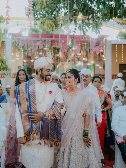 The couple's grand exit after the wedding ceremony, walking together as husband and wife.