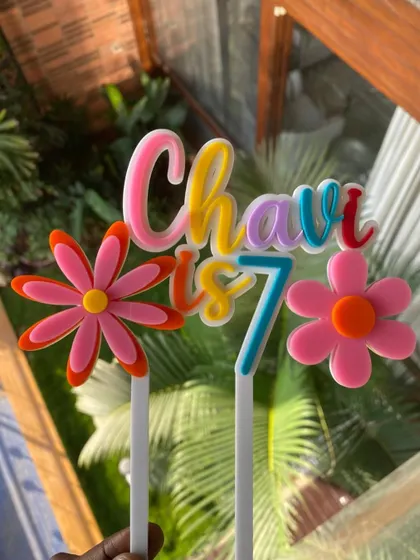 This colorful layered acrylic topper is perfect for a summer birthday. The rainbow lettering and 3D flowers bring a vibrant and cheerful energy.