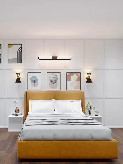 A view focusing on the bed and accent wall, with stylish wall sconces and art creating a balanced and peaceful composition.