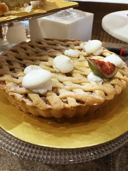 A close-up of our fig and almond tart. The combination of the rustic lattice crust and the fresh, juicy figs creates a dessert that is both comforting and sophisticated.