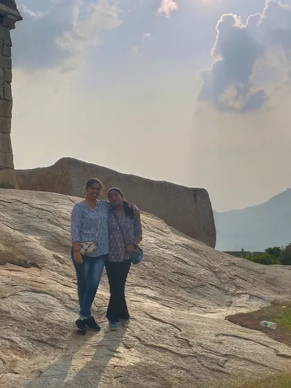 A happy moment captured against the backdrop of ancient fort ruins and a cloudy sky.