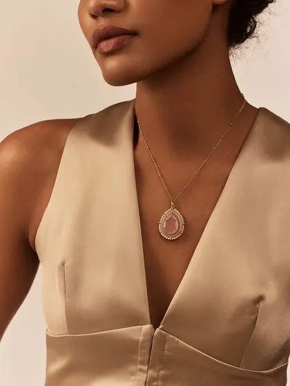 The Gulmohar Dusty Rose Chainette is an elegant and delicate necklace. It sits gracefully on the wearer, perfect for adding a subtle hint of color and sparkle to a simple outfit.