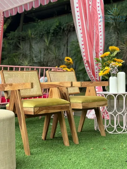 A close-up of the modern wooden chairs used in the lounge area.