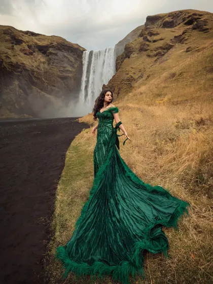 Styling a pre-wedding shoot is about creating pure magic. For Shree's Iceland shoot, we chose this dramatic emerald green gown with ostrich feathers, creating a cinematic and unforgettable look against the epic waterfall.
