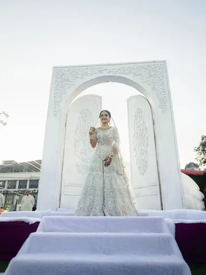 A grand, all-white carved entrance for the bride's walk down the aisle. This set a tone of pure elegance and royalty for the wedding ceremony.