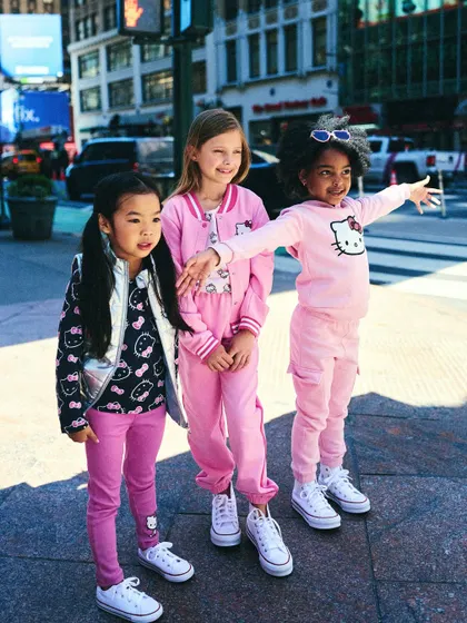 A group of friends exploring the city. This shot captures the essence of a kids' street-style campaign, with confident poses and a real urban backdrop.