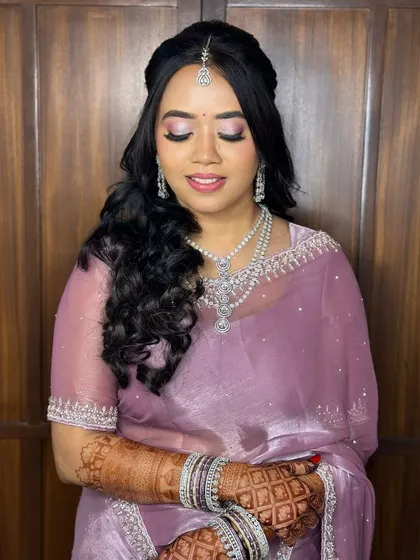 A close-up of the eye makeup. The shimmering eyeshadow and fluttery lashes create a look that is both romantic and glamorous.