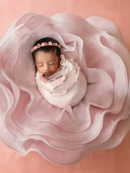 The bloom setup in a beautiful soft pink. This is such a dreamy and artistic way to photograph your newborn girl.