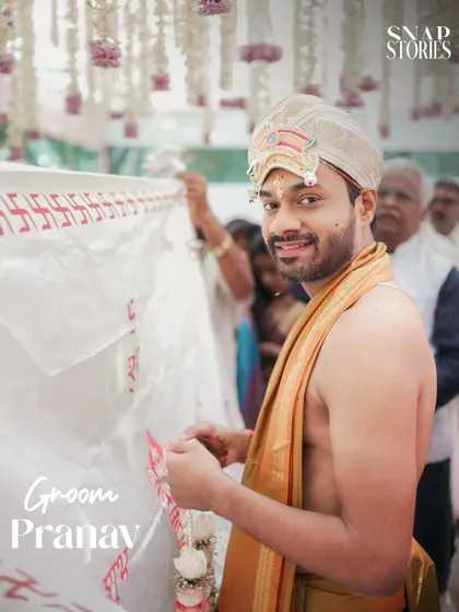 The groom, dressed for a traditional South Indian ceremony, awaits his bride. We capture the anticipation and cultural details of the groom's attire.