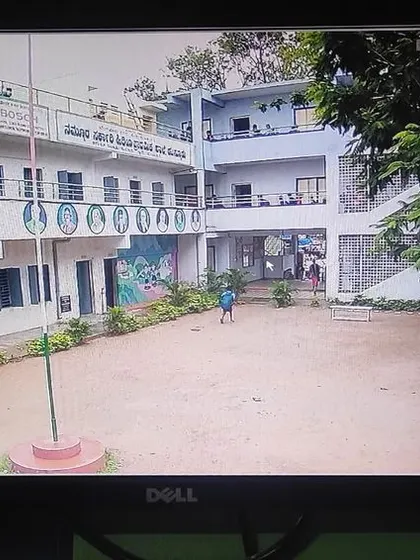 A wide shot of the school courtyard and building exterior.