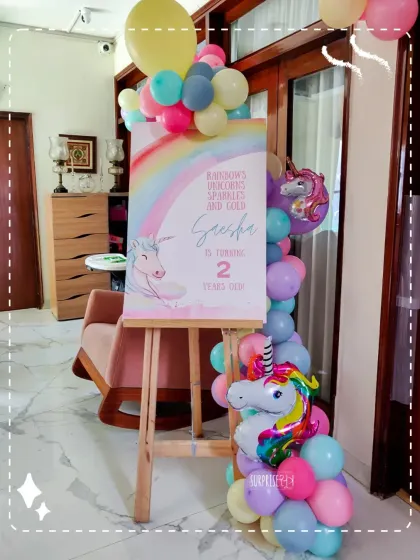 A magical welcome for Saesha's 2nd birthday. The unicorn and rainbow themed welcome sign, complete with a pastel balloon column, set the tone for a fairytale party.