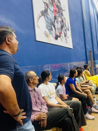 A view from the sidelines, where players and supporters are engrossed in the on-court action.