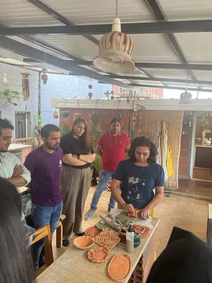 Here I am demonstrating a hand-building technique to the enthusiastic Sugarfit team. I provide step-by-step guidance to make sure everyone feels comfortable and can create something they love.
