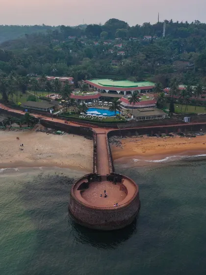 A different angle of Sinquerim Fort, showing its connection to the beach and the nearby resort. It's a beautiful blend of history and leisure.