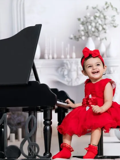 She leaves a little sparkle wherever she goes. This girl's joyful laugh is the highlight of her piano session in our white, elegant studio.