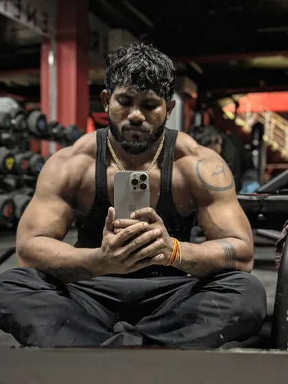 A moment of quiet reflection. Even in rest, the physique tells a story of hard work.
