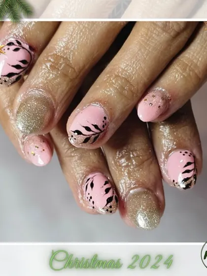A unique holiday design combining a soft pink base with black-and-gold leaf patterns. It's a modern and artistic take on festive nails.