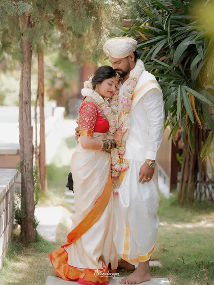 A peaceful embrace in a garden setting. This portrait captures a feeling of comfort, safety, and deep affection between the newly married couple.
