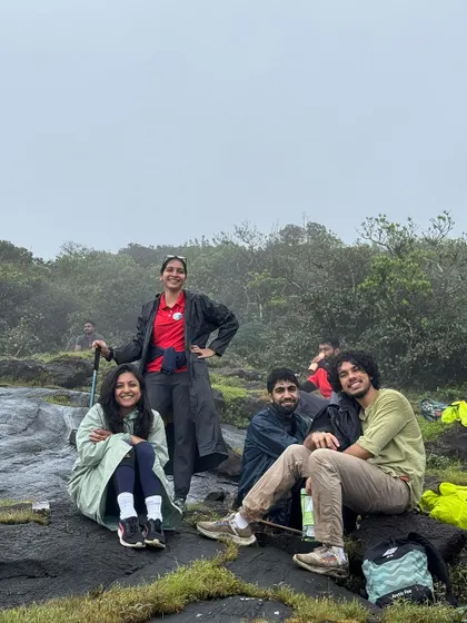 Even on a misty day, the spirits are high. Our trekkers enjoying a moment of rest on the rocks during the Kumara Parvatha climb.