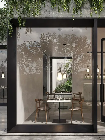 Alibaglass pendants are used to create an intimate dining atmosphere in a modern restaurant with large glass walls. The lights add a touch of elegance without obstructing the view.