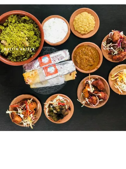 This is the full Babakull's spread, showcasing the variety of dishes inspired by my grandfather's pre-independence era recipes. You can see the Thuppangadi Biriyani, our Kundapur Chicken Ghee Roast Roll, and an assortment of kebabs like the Torpedo Chili, Malabari, and Patta Kebab.