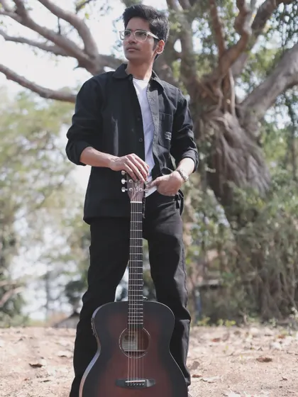 Just me and my guitar, my partner in creating music. This shot really captures how I feel when I'm in my element, ready to share stories through songs.