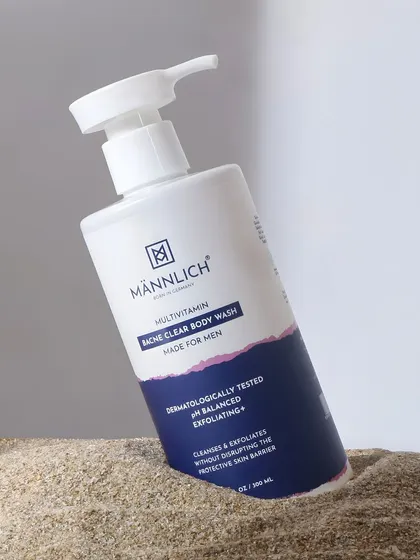 This image places the acne clear body wash in the sand. This suggests it's the perfect product to use after a day outdoors or at the beach, connecting it to an active lifestyle.
