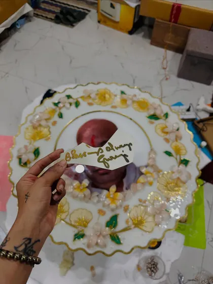 A work-in-progress shot of the large Guruji frame. Here, I'm holding up the "Blessings Always Guruji" text before adding it to the final piece. Grateful for every step of the creative process.